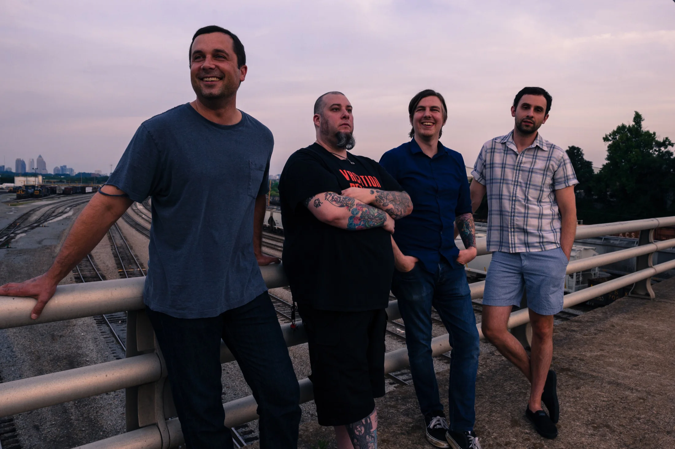 The four members of Vostok Programme standing together above rail tracks in Atlanta